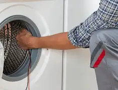 Dryer repair technician diagnosing and servicing a clothes dryer in Honolulu, HI
