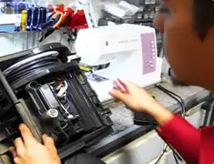 Vacuum repair technician servicing internal components on a workbench in Honolulu, HI