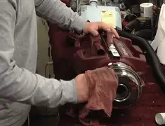 Vacuum repair technician cleaning and servicing a vacuum motor in Honolulu, HI