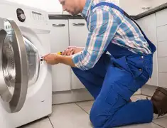 Washing machine repair technician servicing a front-load washer in Honolulu, HI