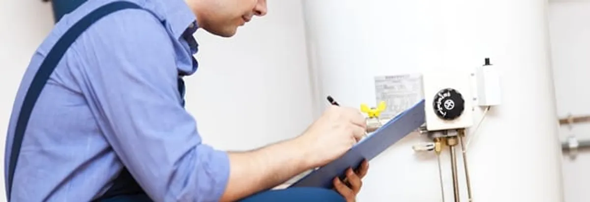 Water heater repair technician inspecting the unit and recording service notes in Honolulu, HI